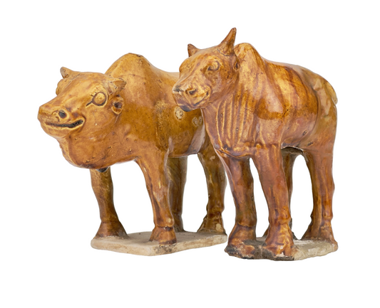 AMBER-GLAZED POTTERY FIGURE OF TWO SACRED BULLS, TANG DYNASTY (7-10TH CENTURY)