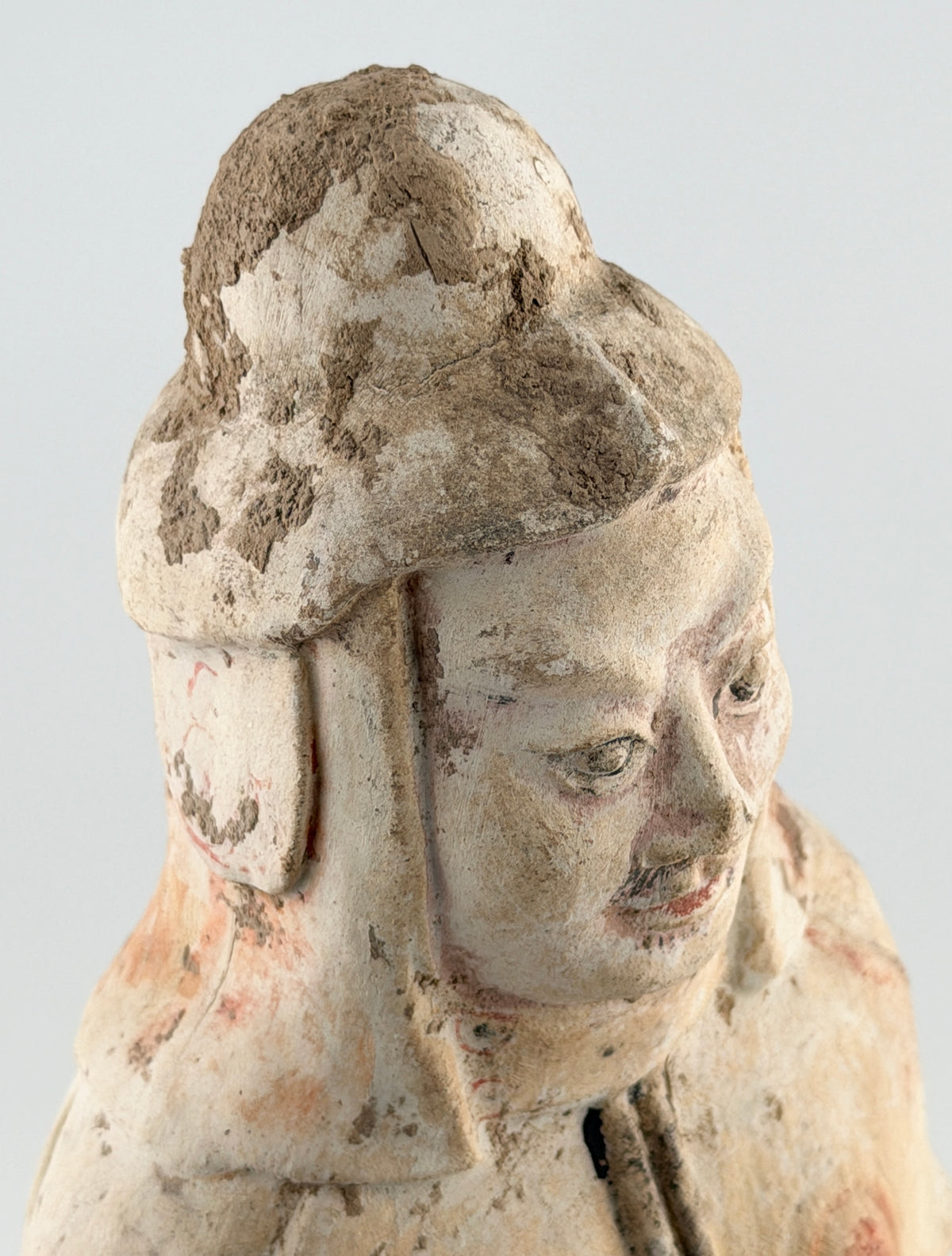 Sui-Tang Dynasty pottery warrior figure with raised arm, clenched fists, layered chest and shoulder armor, and original pigments.