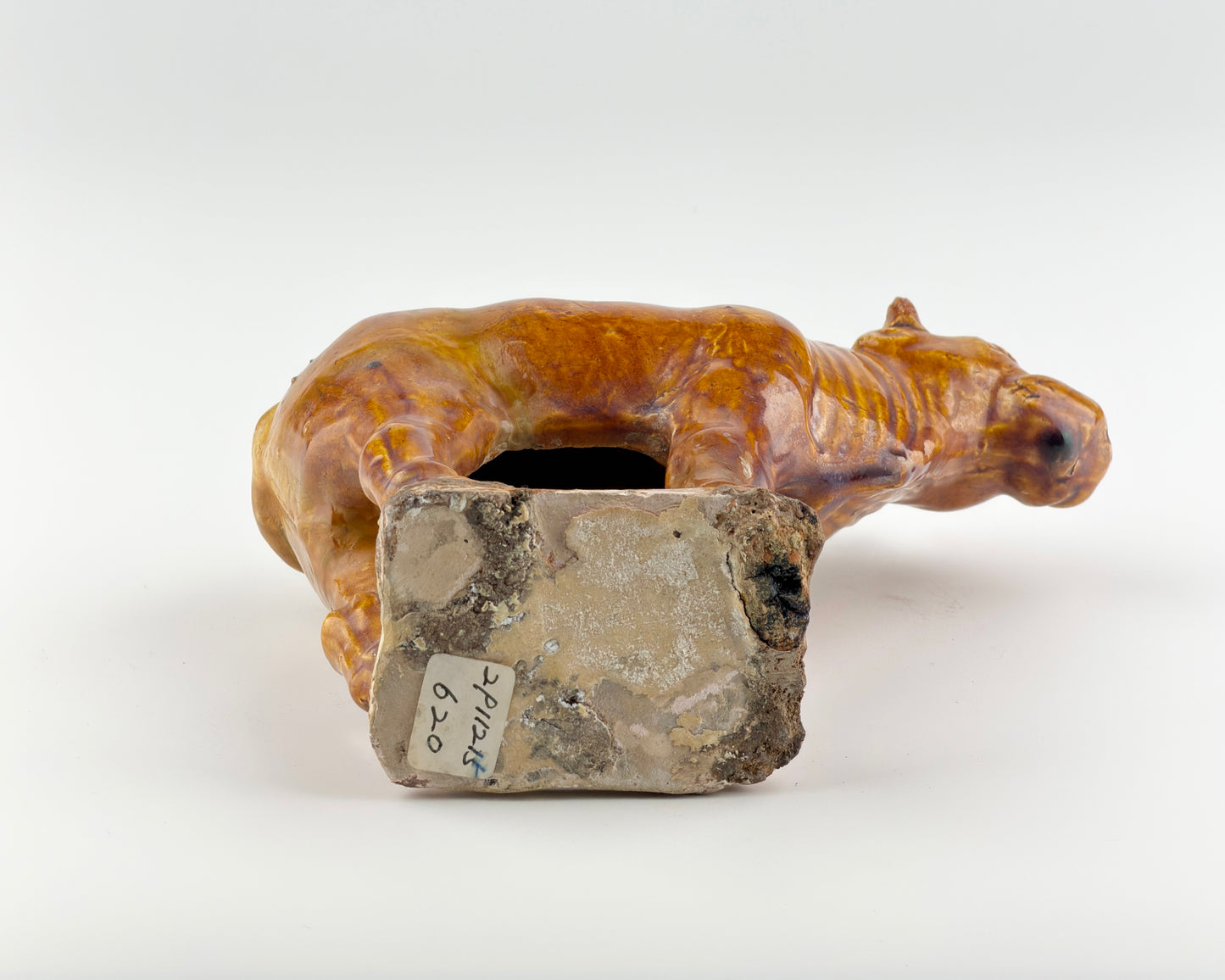 AMBER-GLAZED POTTERY FIGURE OF SACRED BULL, TANG-LIAO DYNASTY (7-12TH CENTURY)