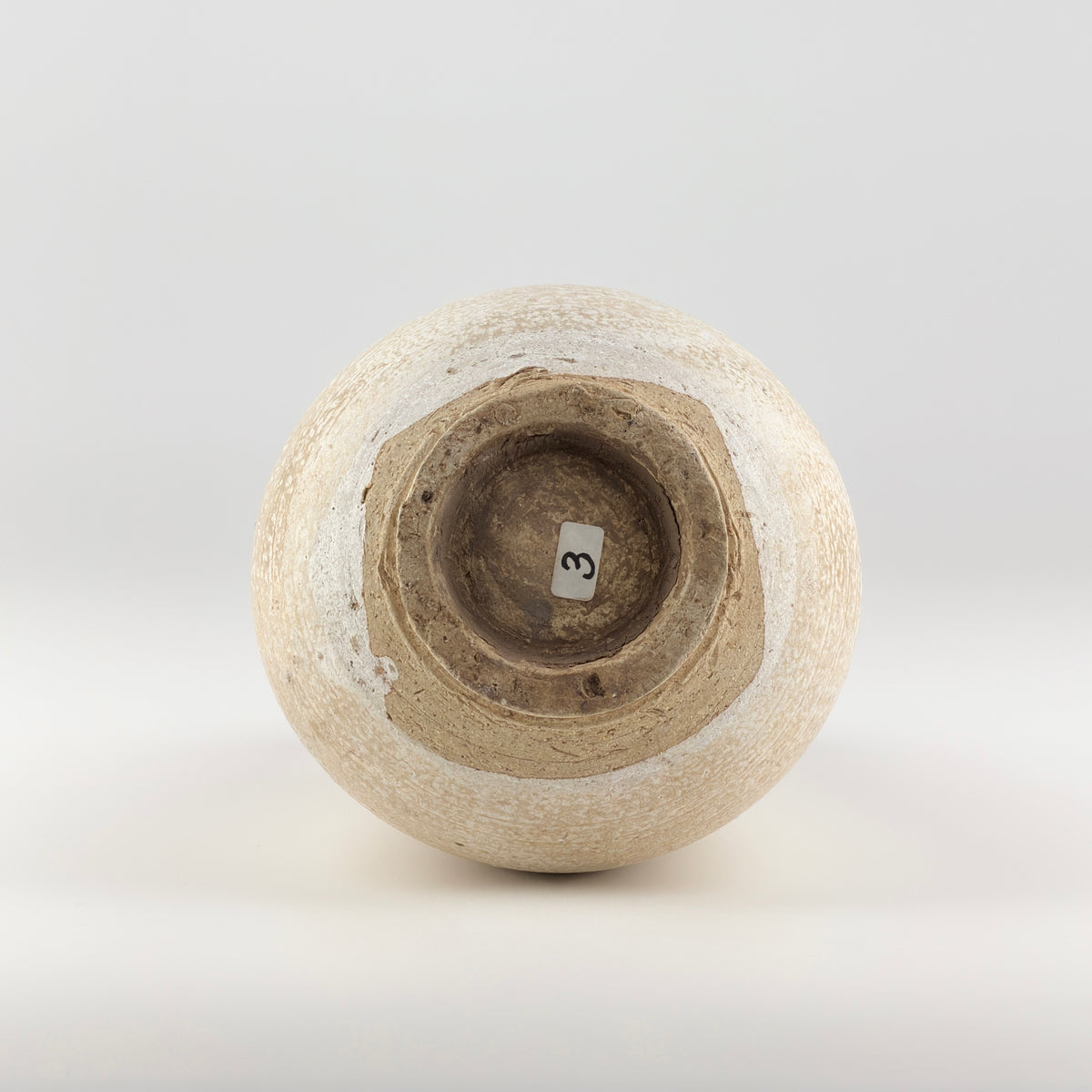 Liao Dynasty white-glazed chicken-comb ewer with a rounded body, inspired by nomadic leather water flasks.