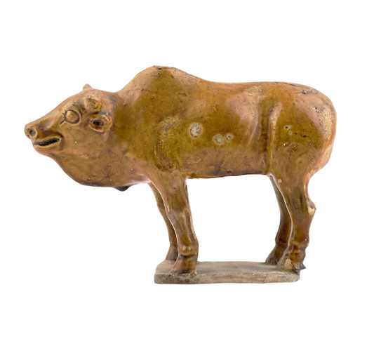 AMBER-GLAZED POTTERY FIGURE OF SACRED BULL, TANG-LIAO DYNASTY (7-12TH CENTURY)