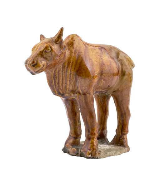 AMBER-GLAZED POTTERY FIGURE OF SACRED BULL, TANG-LIAO DYNASTY (7-12TH CENTURY)