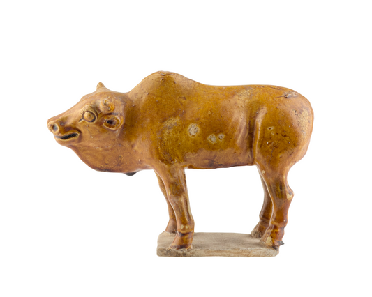 AMBER-GLAZED POTTERY FIGURE OF SACRED BULL, TANG-LIAO DYNASTY (7-12TH CENTURY)