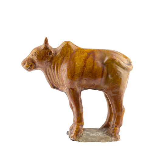 AMBER-GLAZED POTTERY FIGURE OF SACRED BULL, TANG-LIAO DYNASTY (7-12TH CENTURY)
