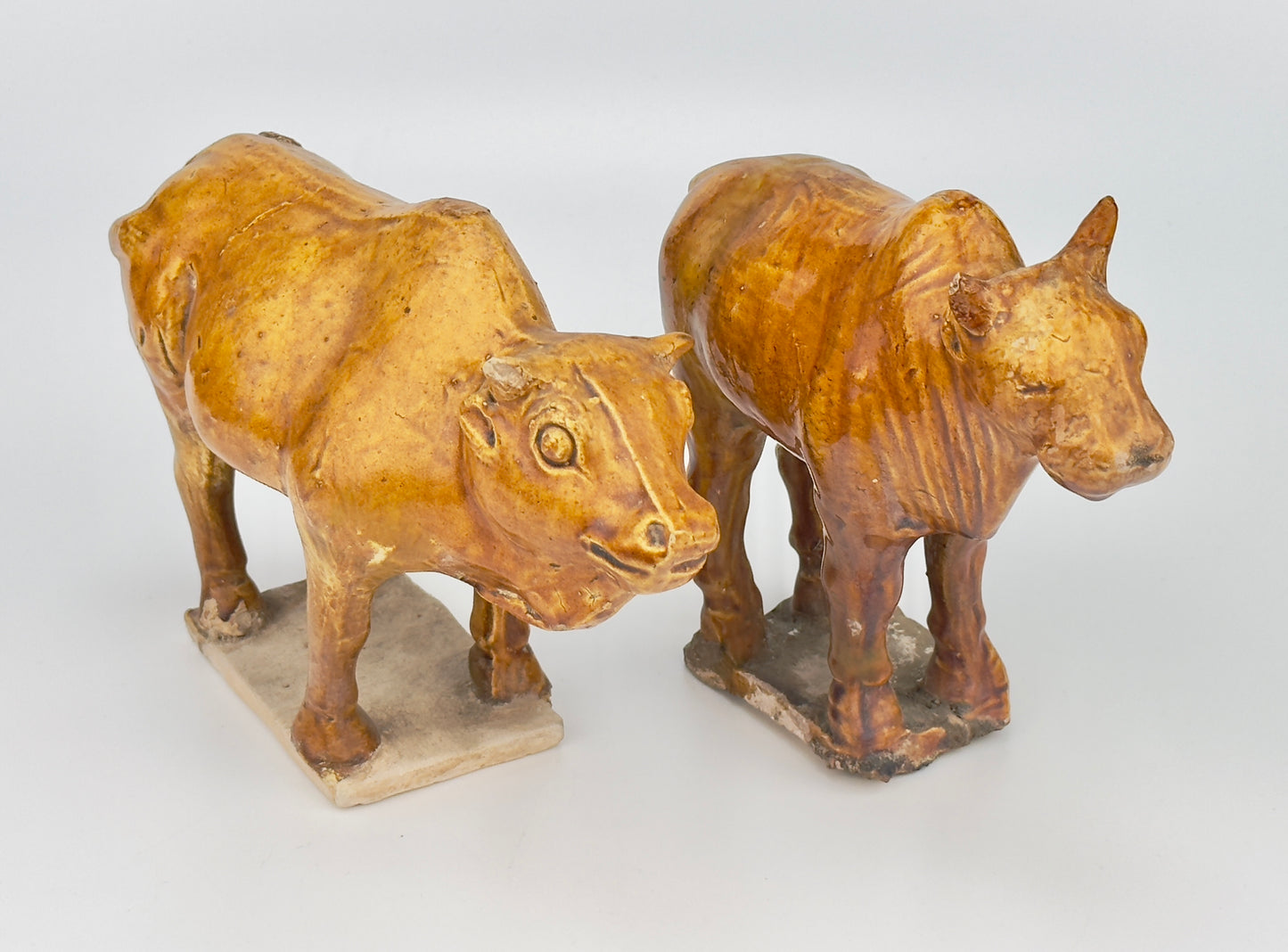 AMBER-GLAZED POTTERY FIGURE OF TWO SACRED BULLS, TANG-LIAO DYNASTY (7-12TH CENTURY)