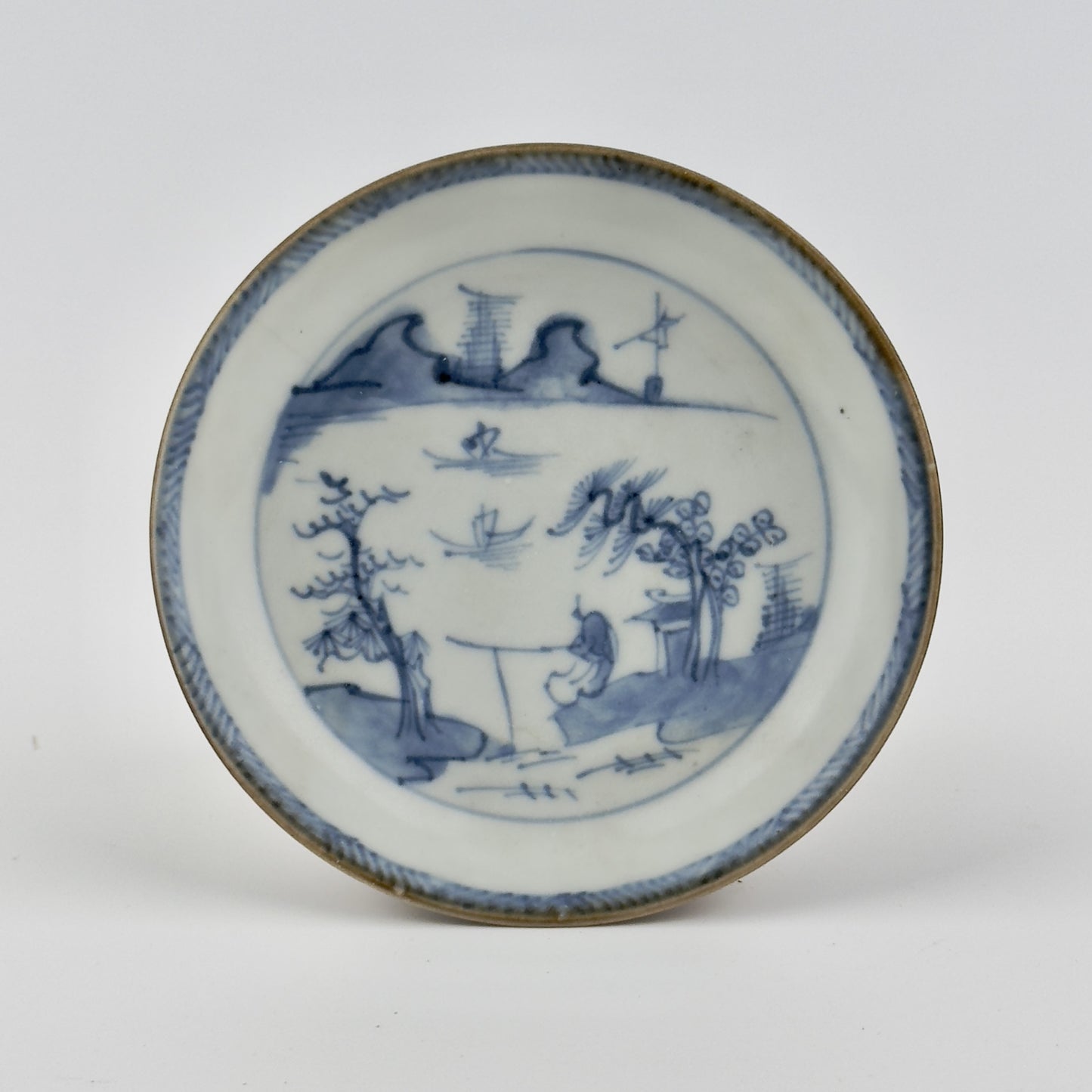 PASSING BOAT AND FIGURE PATTERN BLUE AND WHITE SAUCER, CIRCA 1725, QING DYNASTY, YONGZHENG ERA