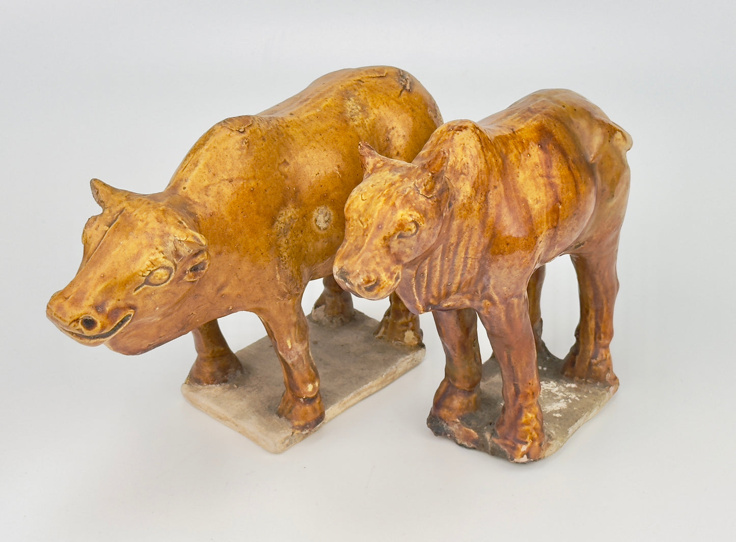 AMBER-GLAZED POTTERY FIGURE OF TWO SACRED BULLS, TANG-LIAO DYNASTY (7-12TH CENTURY)