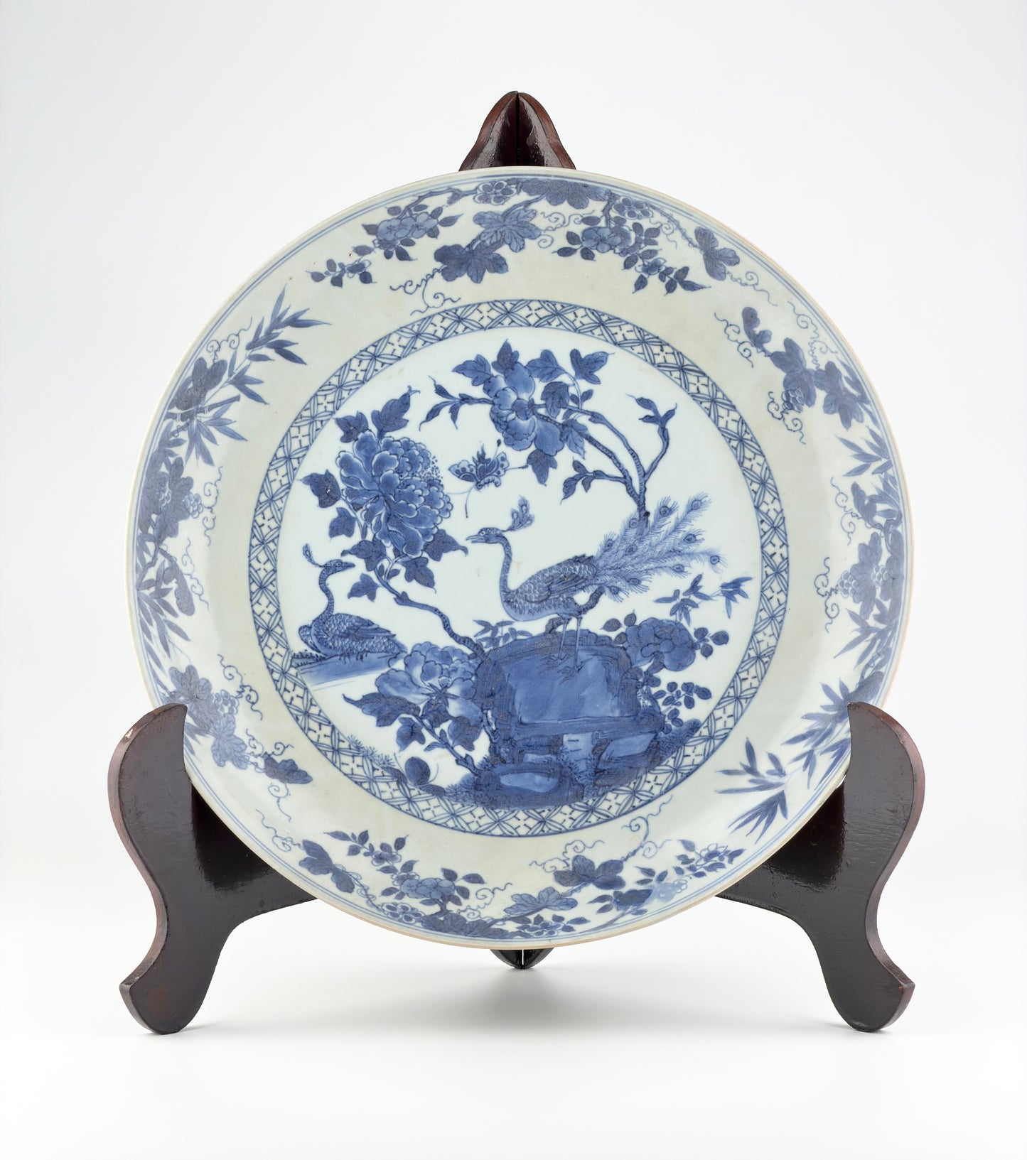 PEACOCK IN SPLENDOUR PATTERN BLUE AND WHITE DISH CIRCA 1725, QING DYNASTY, YONGZHENG