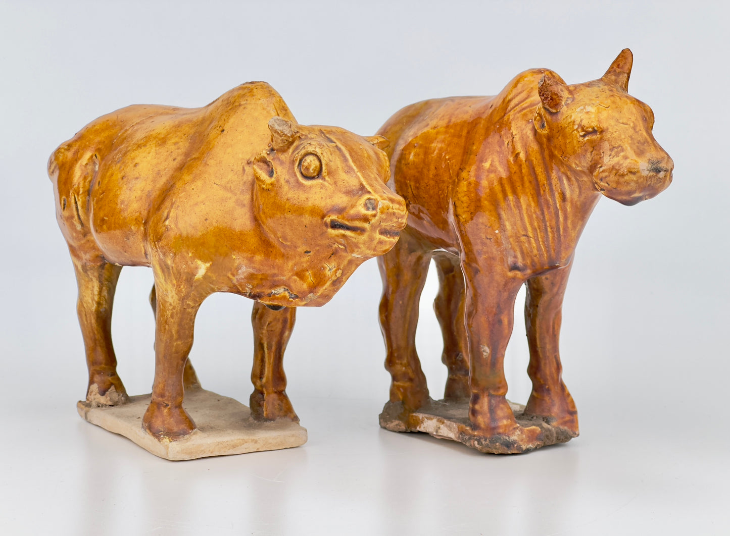 AMBER-GLAZED POTTERY FIGURE OF TWO SACRED BULLS, TANG-LIAO DYNASTY (7-12TH CENTURY)