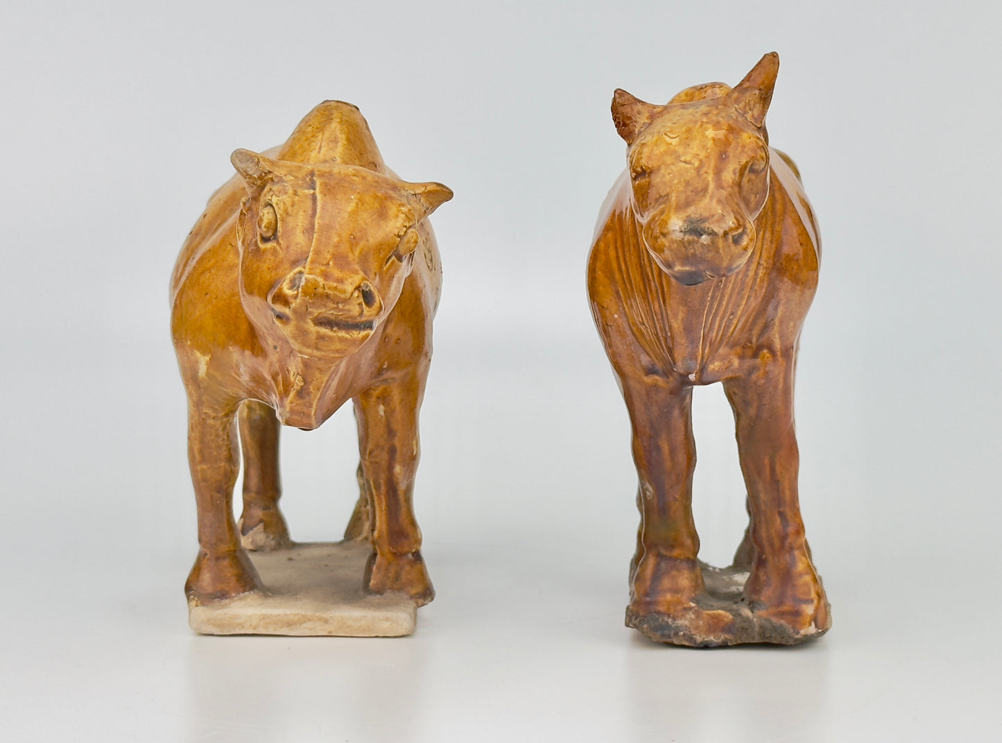 AMBER-GLAZED POTTERY FIGURE OF TWO SACRED BULLS, TANG-LIAO DYNASTY (7-12TH CENTURY)