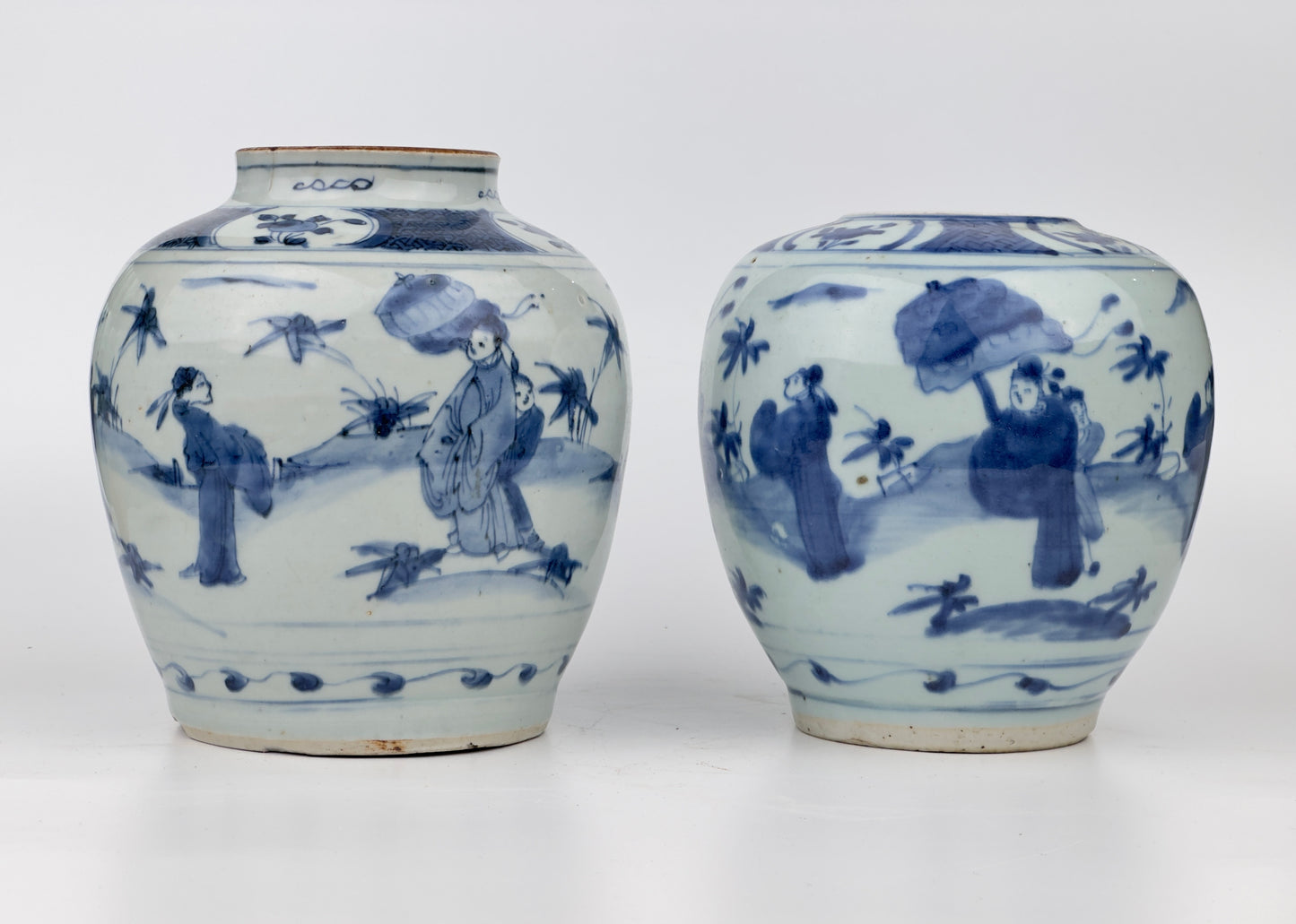 Two Chinese blue and white jars, painted with eight figures in a garden, marked on the bottom with a sitting rabbit(blue hare), Transitional period(Late Ming dynasty)