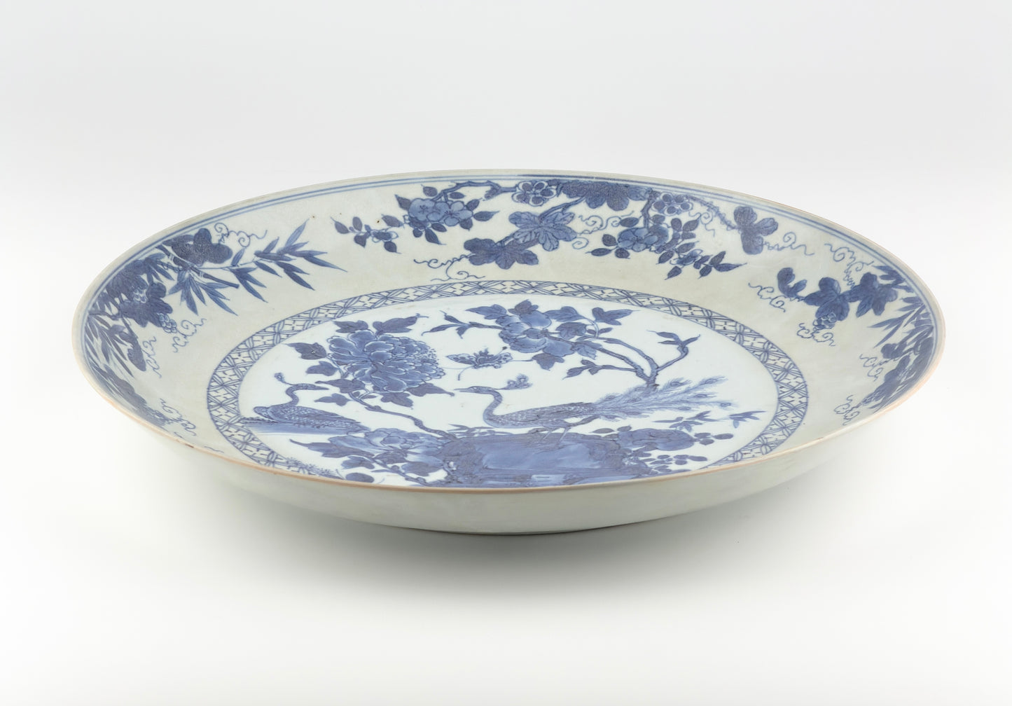 PEACOCK IN SPLENDOUR PATTERN BLUE AND WHITE DISH CIRCA 1725, QING DYNASTY, YONGZHENG