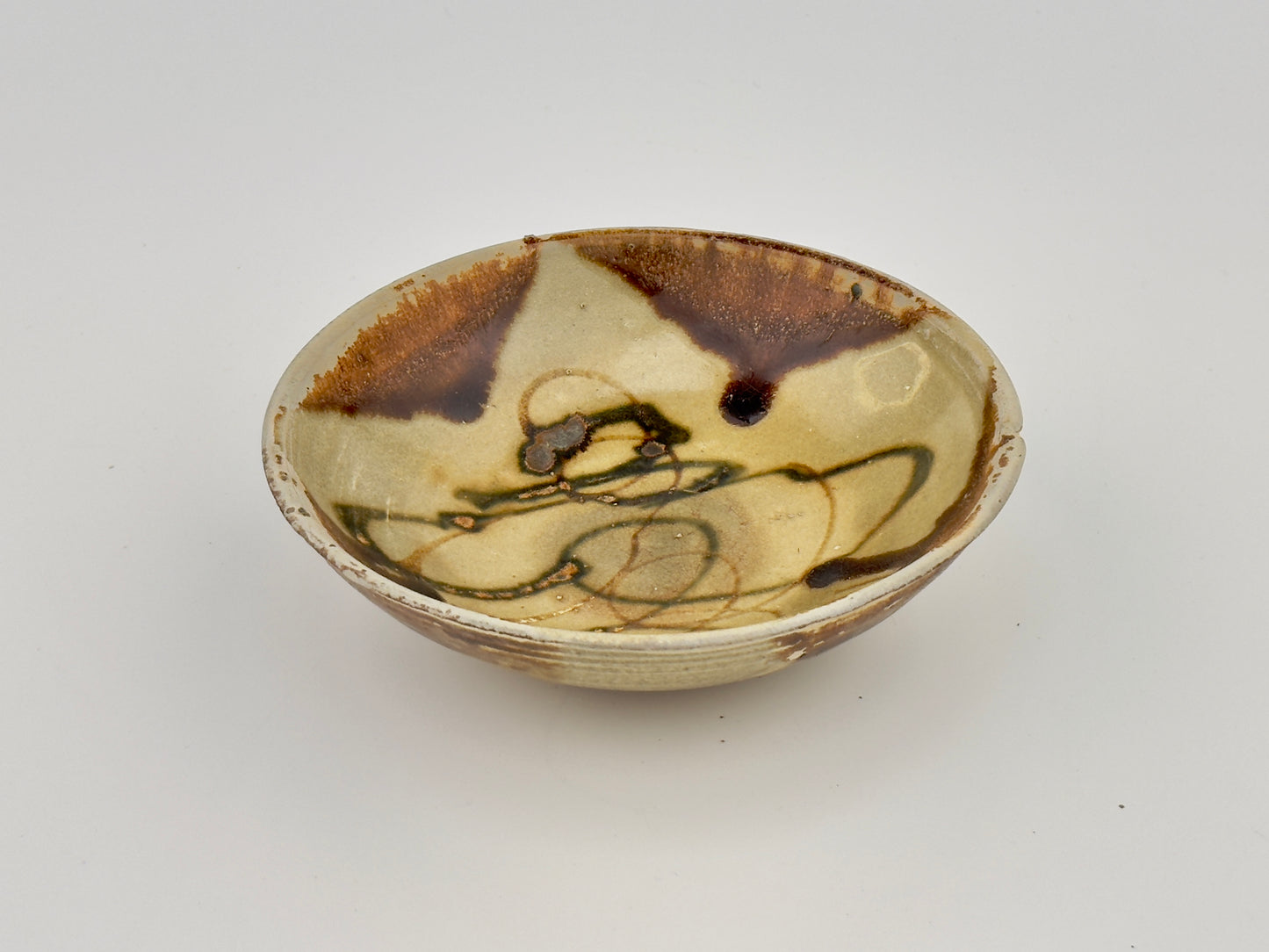 BELITUNG SHIP, CHANGSHA BOWL WITH ABSTRACT PATTERNS PRESUMED TO BE ISLAMIC SYMBOLS, TANG PERIOD