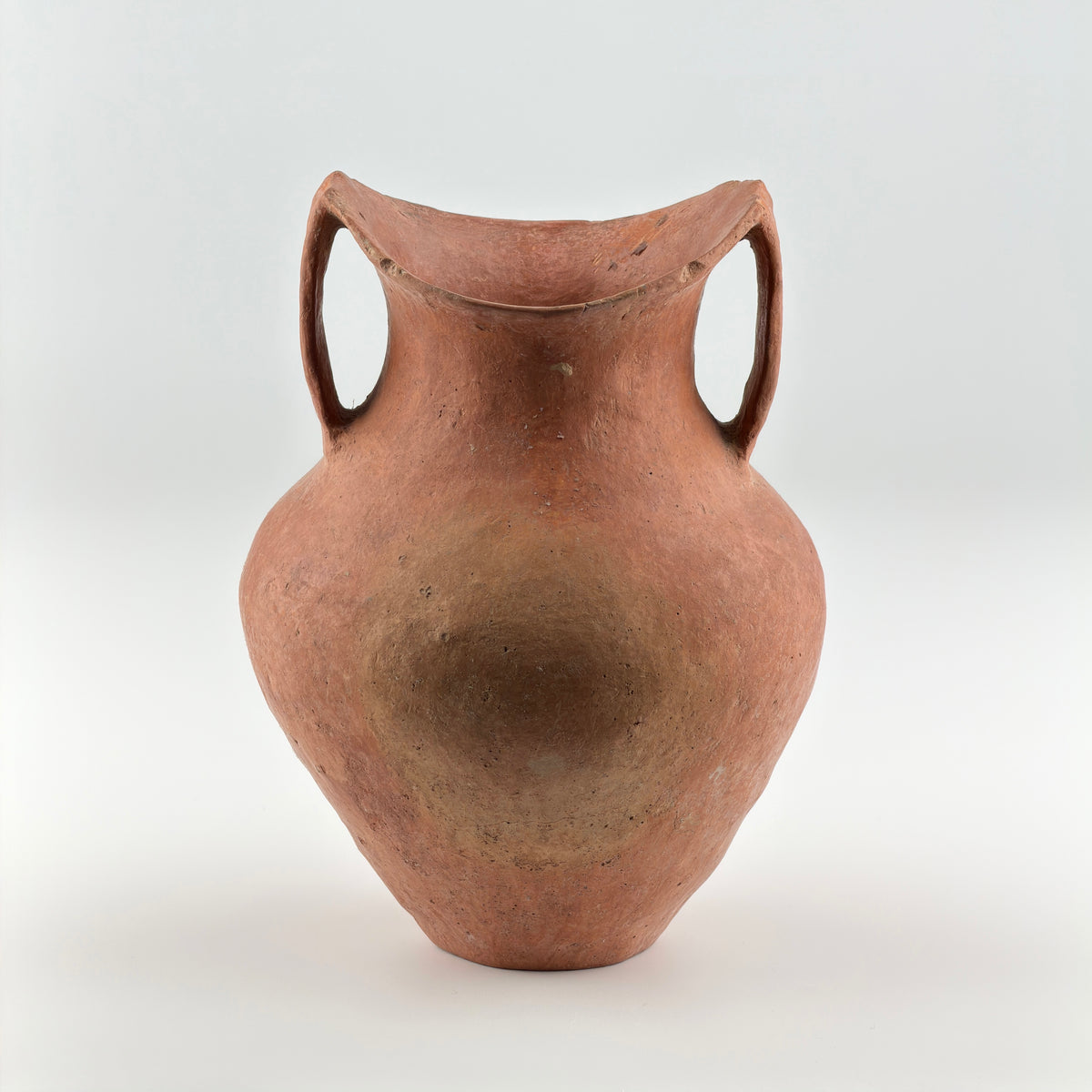 Neolithic Siwa Culture burnished pottery jar with reddish-brown body, ovoid form, and twin loop handles.