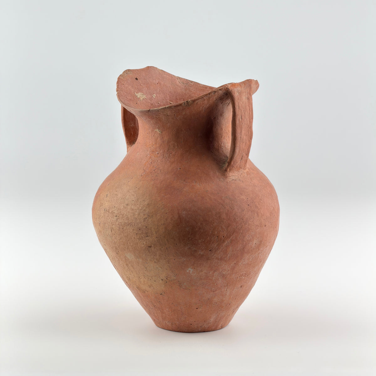 Neolithic Siwa Culture burnished pottery jar with reddish-brown body, ovoid form, and twin loop handles.