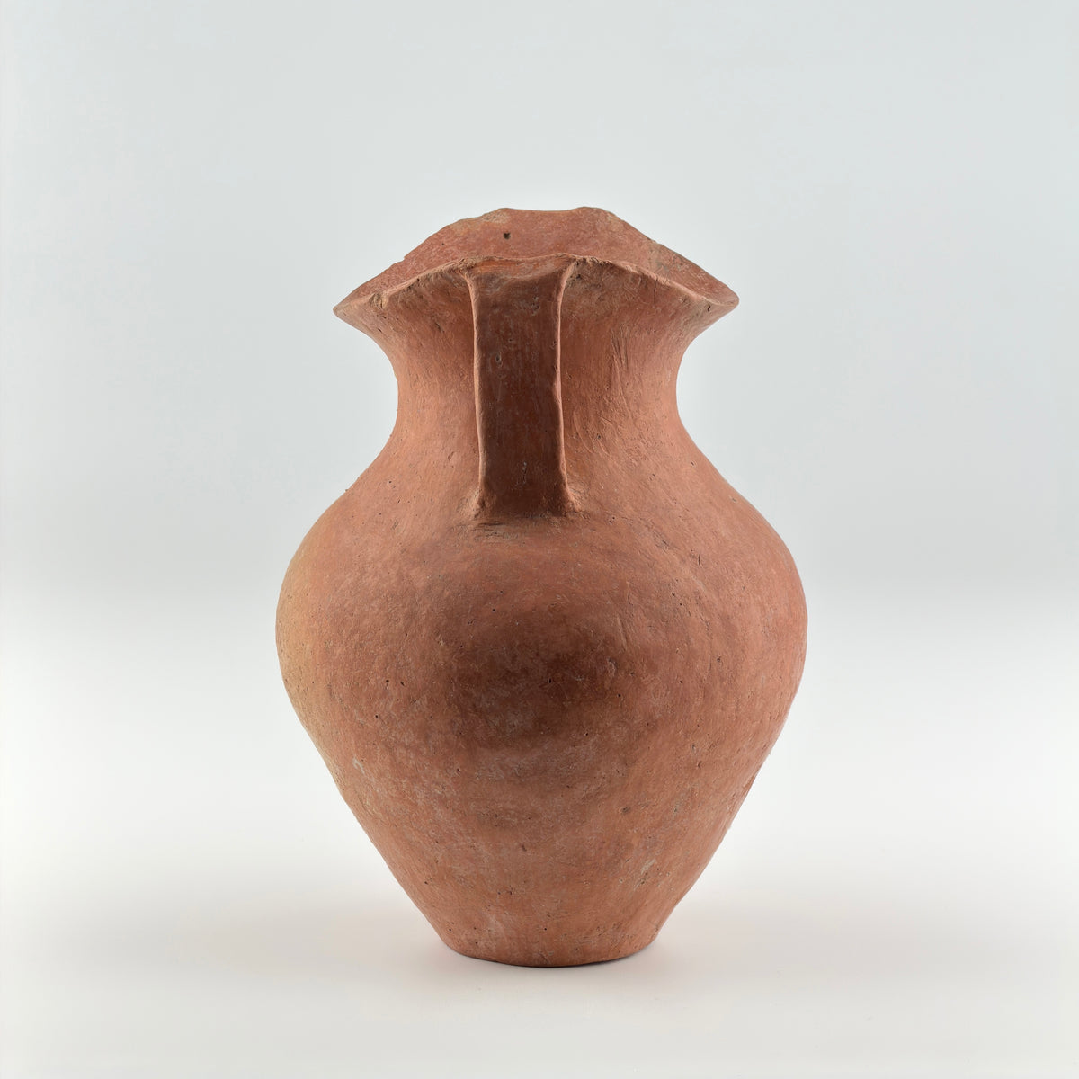 Neolithic Siwa Culture burnished pottery jar with reddish-brown body, ovoid form, and twin loop handles.