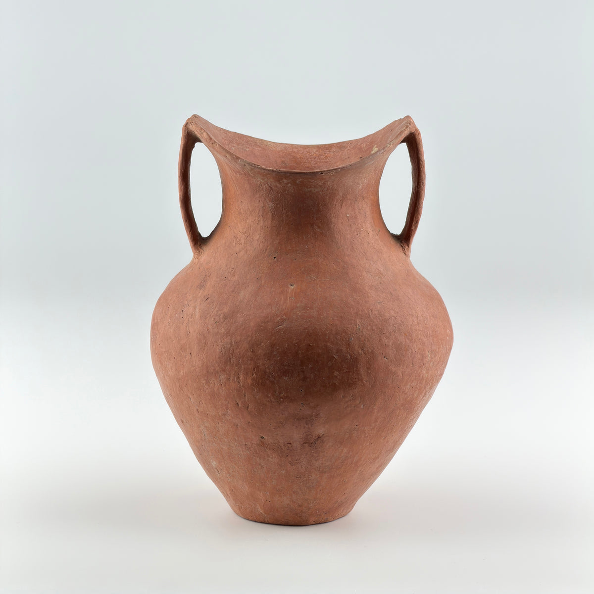 Neolithic Siwa Culture burnished pottery jar with reddish-brown body, ovoid form, and twin loop handles.