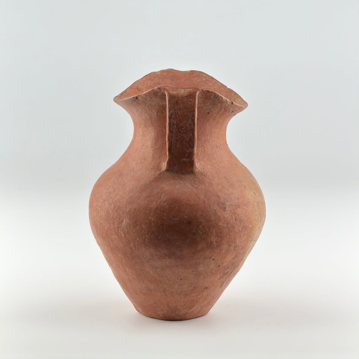 Neolithic Siwa Culture burnished pottery jar with reddish-brown body, ovoid form, and twin loop handles.