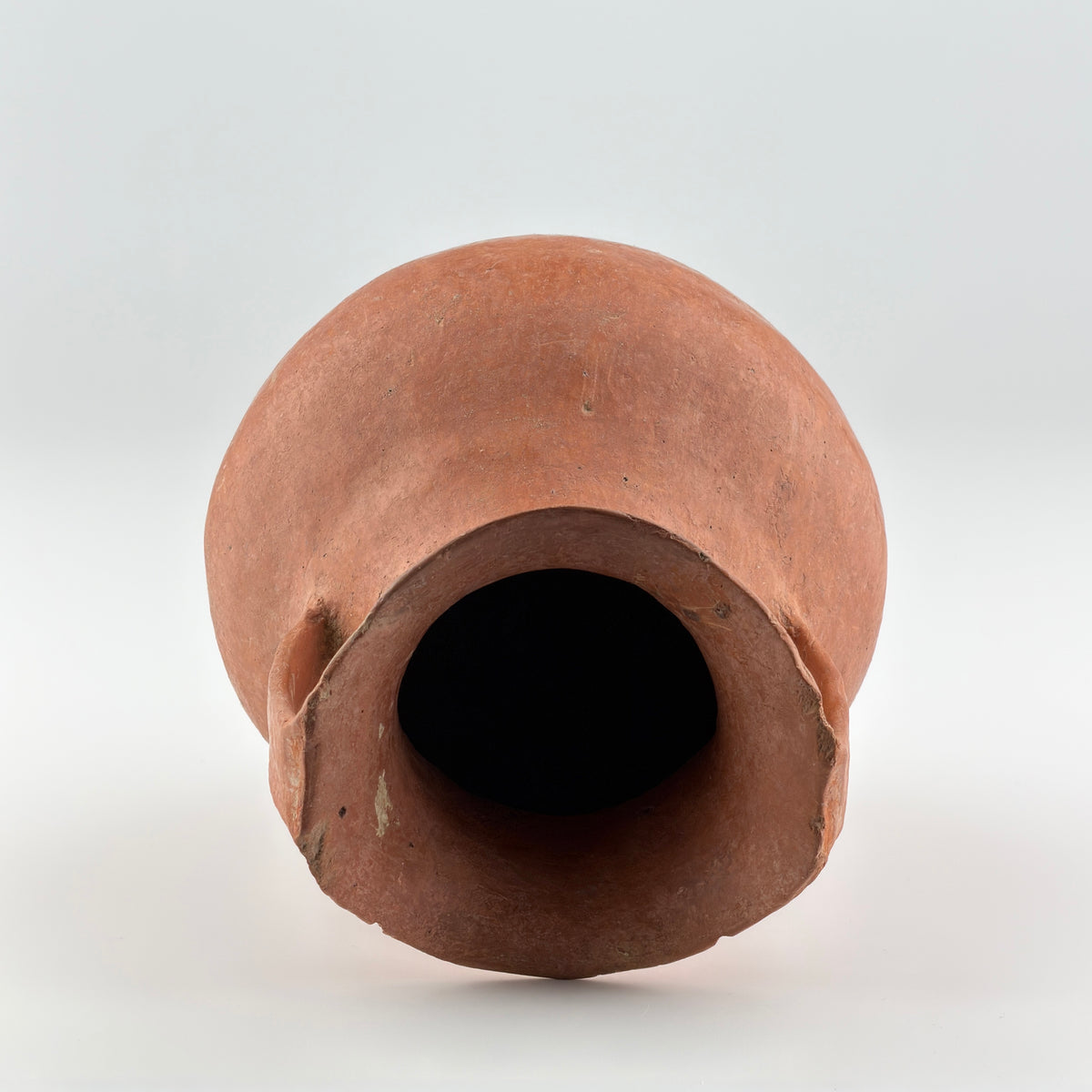 Neolithic Siwa Culture burnished pottery jar with reddish-brown body, ovoid form, and twin loop handles.