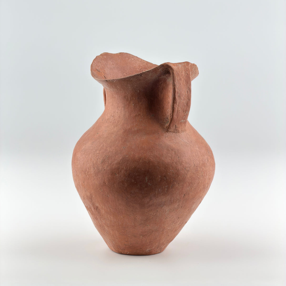 Neolithic Siwa Culture burnished pottery jar with reddish-brown body, ovoid form, and twin loop handles.