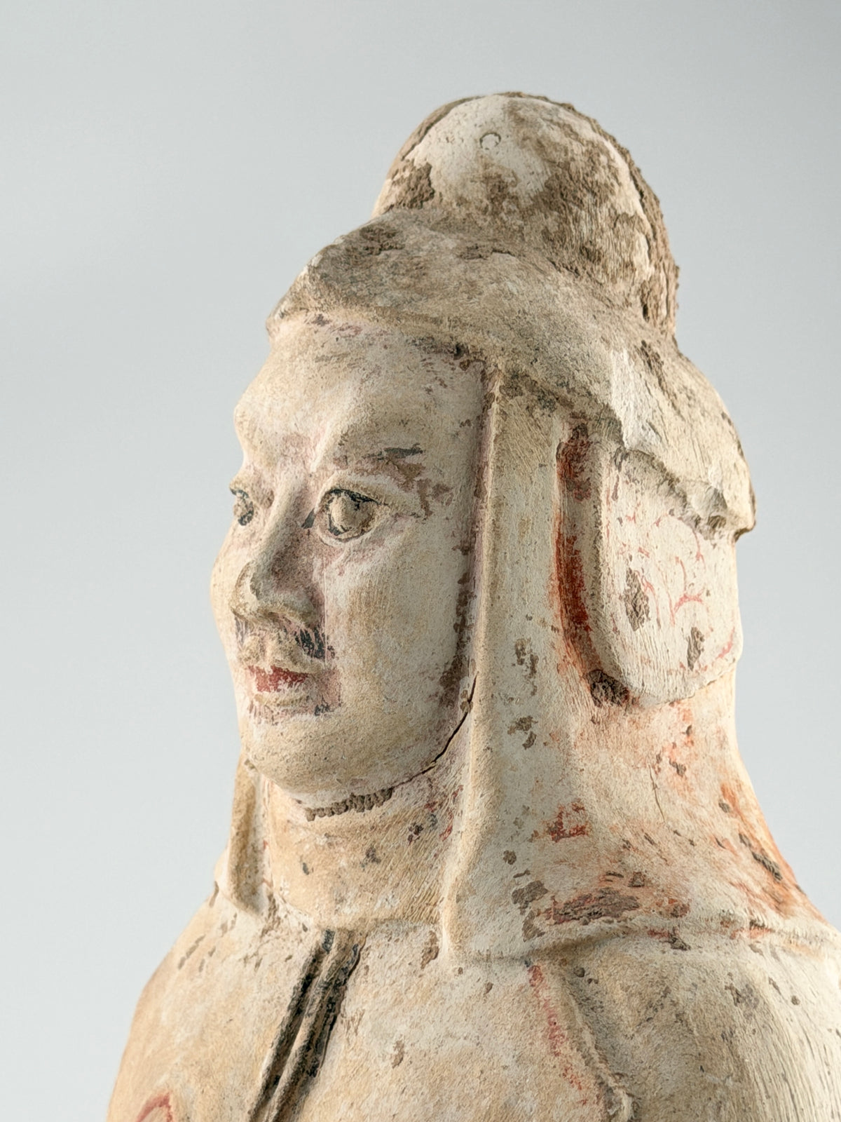 Sui-Tang Dynasty pottery warrior figure with raised arm, clenched fists, layered chest and shoulder armor, and original pigments.