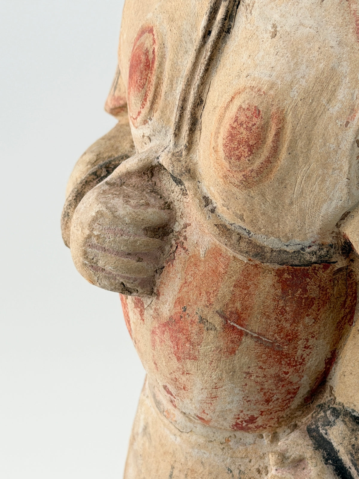 Sui-Tang Dynasty pottery warrior figure with raised arm, clenched fists, layered chest and shoulder armor, and original pigments.