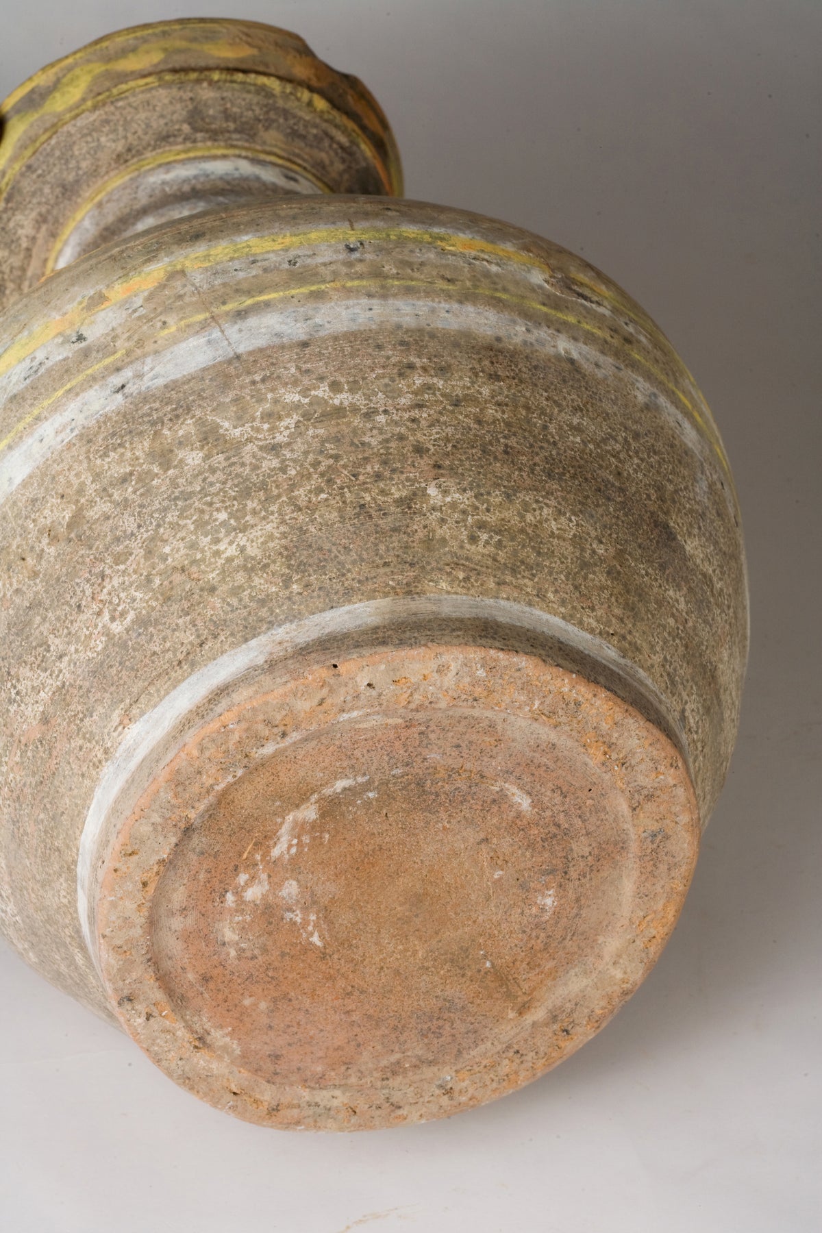 Han Dynasty earthenware pottery jar with mountain-shaped cover, painted yellow, white and black bands, and circular motifs.