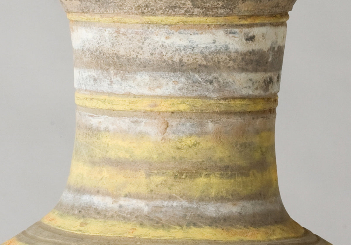 Han Dynasty earthenware pottery jar with mountain-shaped cover, painted yellow, white and black bands, and circular motifs.