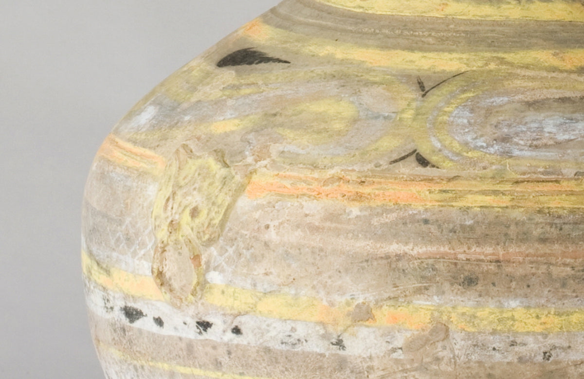 Han Dynasty earthenware pottery jar with mountain-shaped cover, painted yellow, white and black bands, and circular motifs.