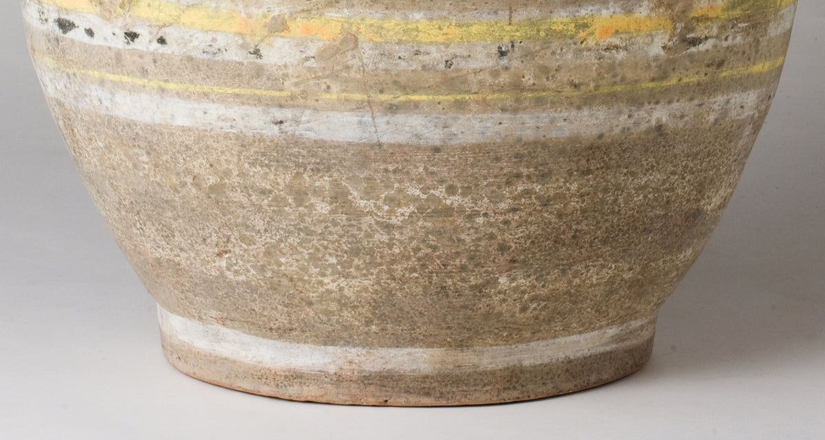 Han Dynasty earthenware pottery jar with mountain-shaped cover, painted yellow, white and black bands, and circular motifs.