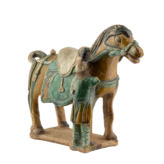 Ming Dynasty pottery horse and rider figures with green and amber glazes, standing on rectangular bases.