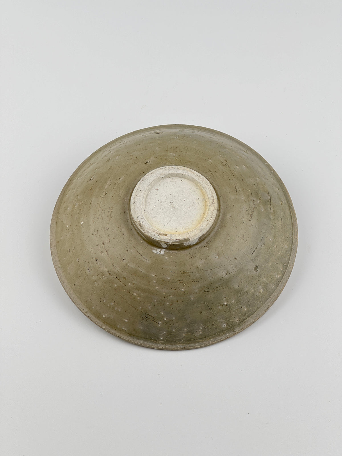 Song Dynasty celadon bowl with incised lotus flower and leaf patterns, soft grayish-green glaze, and fine surface crackling.
