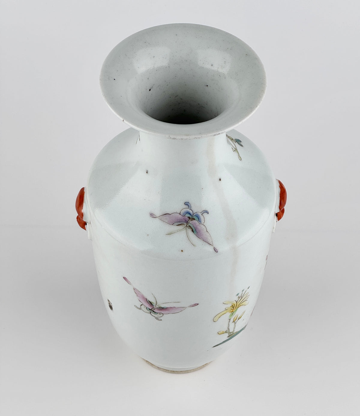 Famille rose porcelain vase, Late Qing-Republic period, with golden pheasant, peonies, butterflies, and iron-red beast-head handles.