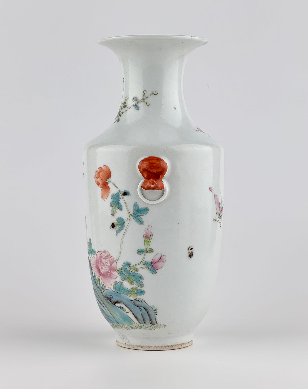 Famille rose porcelain vase, Late Qing-Republic period, with golden pheasant, peonies, butterflies, and iron-red beast-head handles.