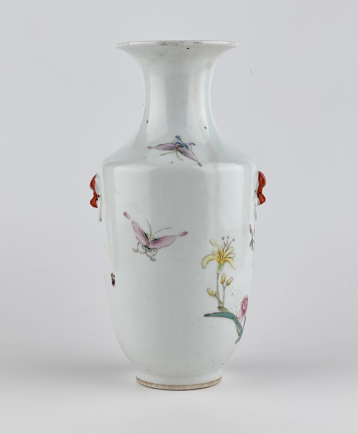Famille rose porcelain vase, Late Qing-Republic period, with golden pheasant, peonies, butterflies, and iron-red beast-head handles.