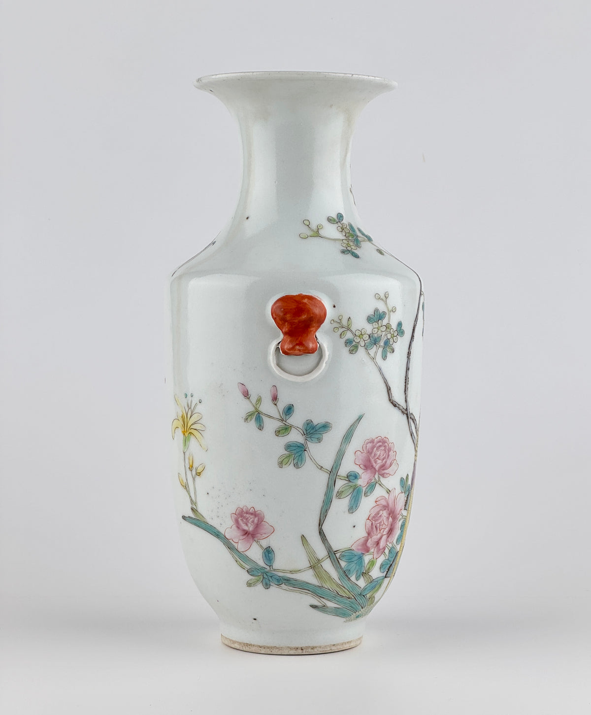 Famille rose porcelain vase, Late Qing-Republic period, with golden pheasant, peonies, butterflies, and iron-red beast-head handles.