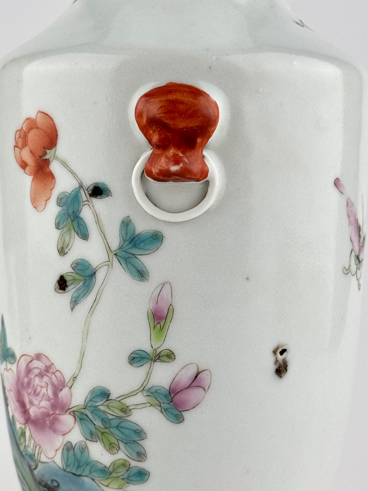 Famille rose porcelain vase, Late Qing-Republic period, with golden pheasant, peonies, butterflies, and iron-red beast-head handles.