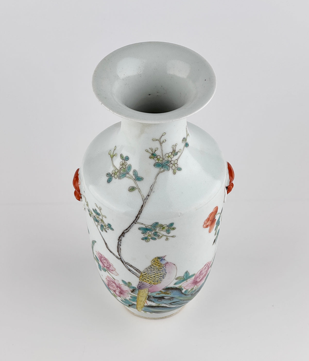 Famille rose porcelain vase, Late Qing-Republic period, with golden pheasant, peonies, butterflies, and iron-red beast-head handles.
