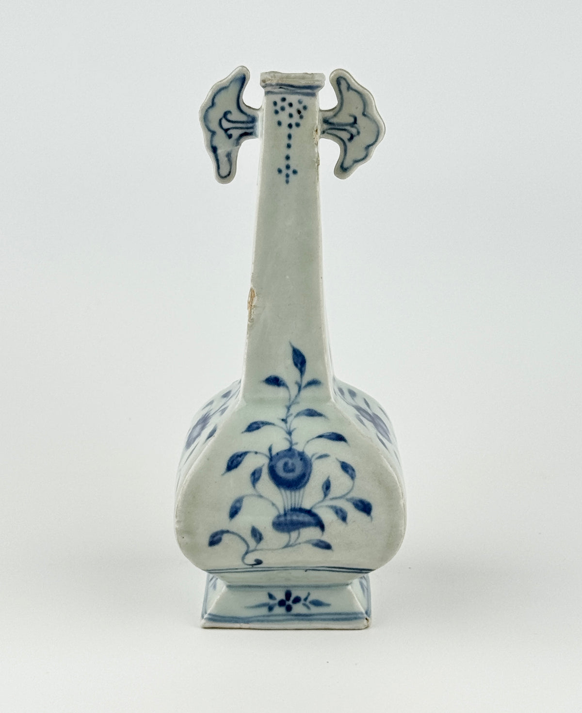 Ming-Qing blue and white porcelain four-sided vase with underglaze-blue floral scrolls and a softly glazed surface.