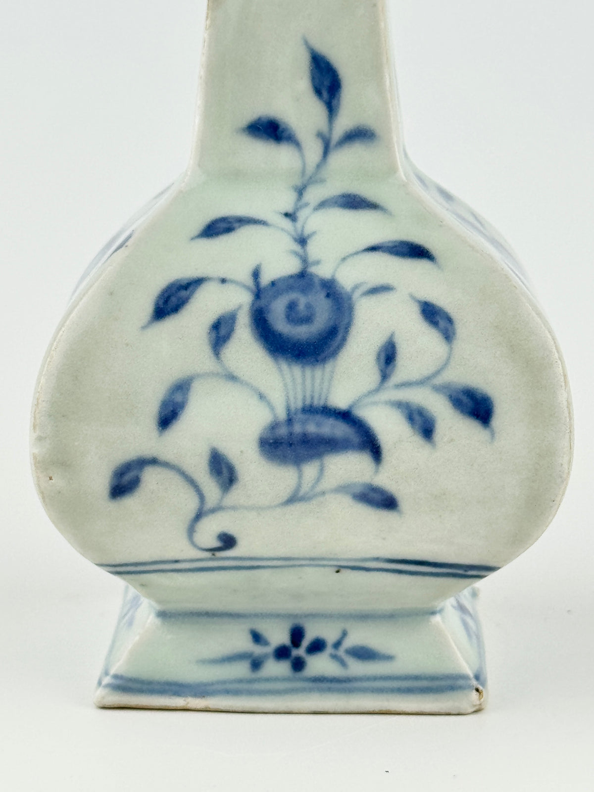 Ming-Qing blue and white porcelain four-sided vase with underglaze-blue floral scrolls and a softly glazed surface.