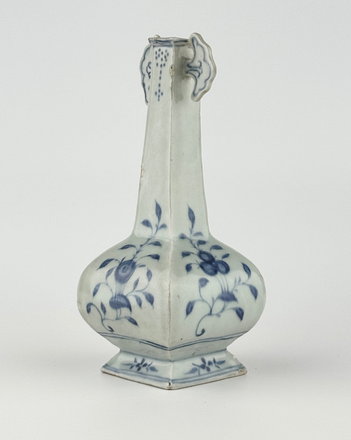 Ming-Qing blue and white porcelain four-sided vase with underglaze-blue floral scrolls and a softly glazed surface.