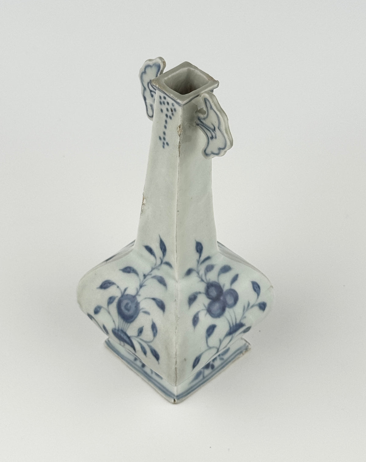 Ming-Qing blue and white porcelain four-sided vase with underglaze-blue floral scrolls and a softly glazed surface.