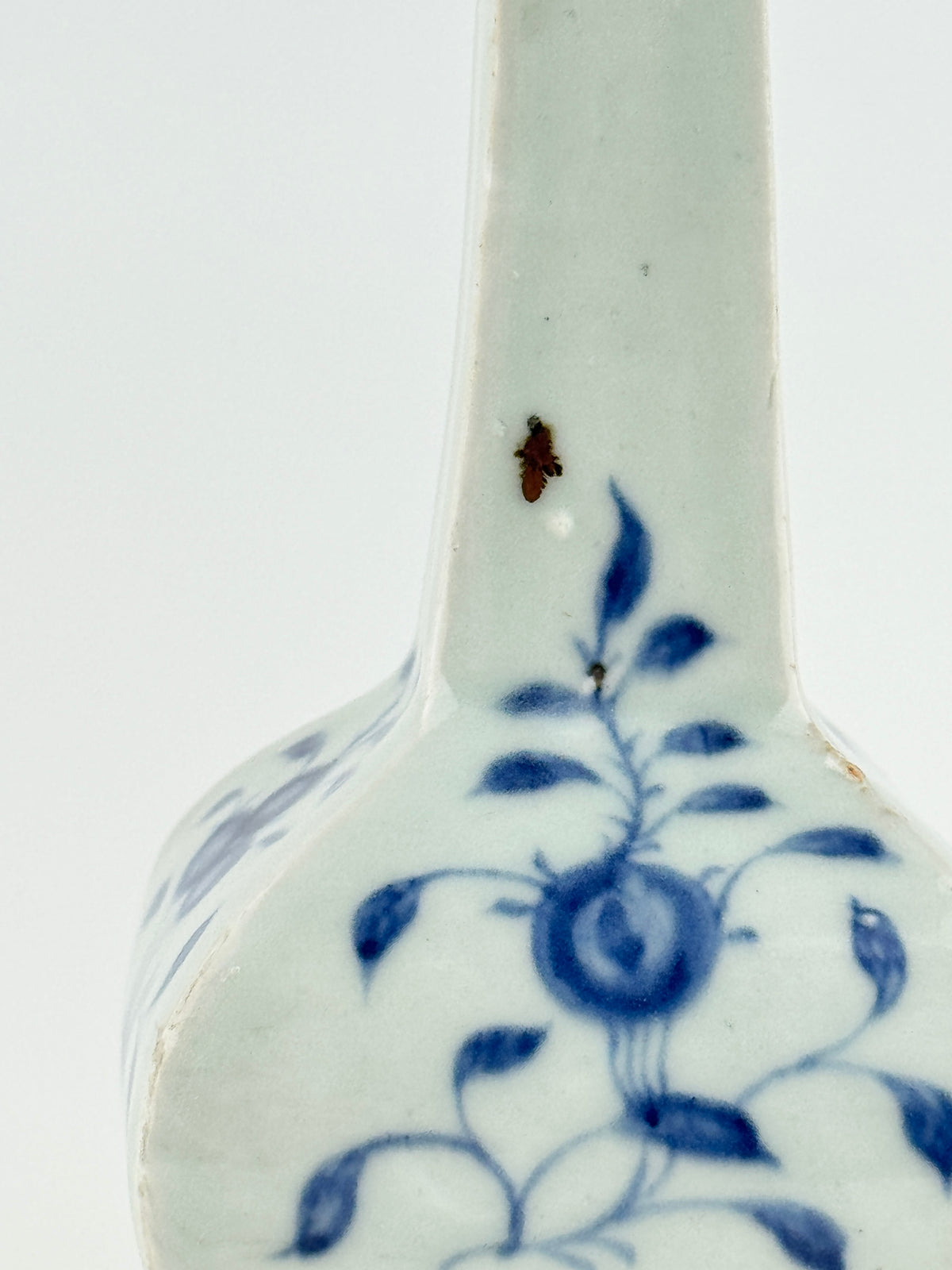 Ming-Qing blue and white porcelain four-sided vase with underglaze-blue floral scrolls and a softly glazed surface.