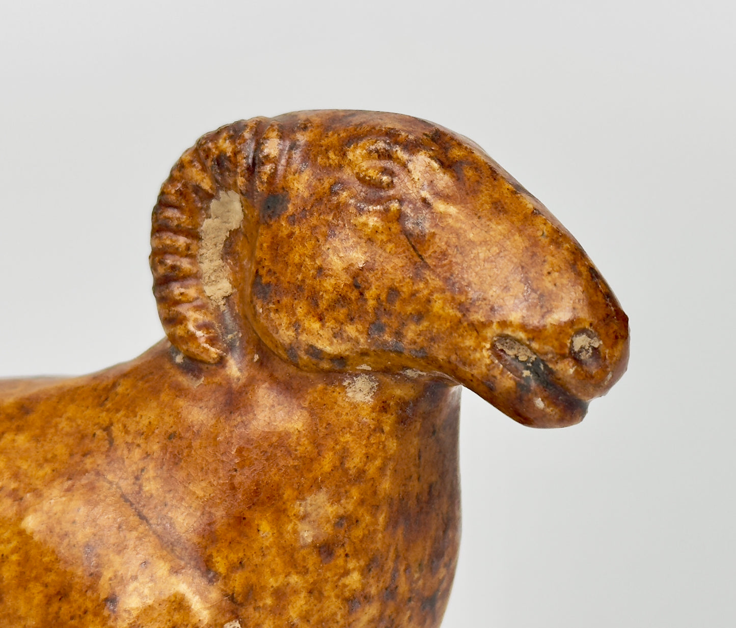 AMBER-GLAZED POTTERY FIGURE OF SHEEP, TANG-LIAO DYNASTY (7-12TH CENTURY)