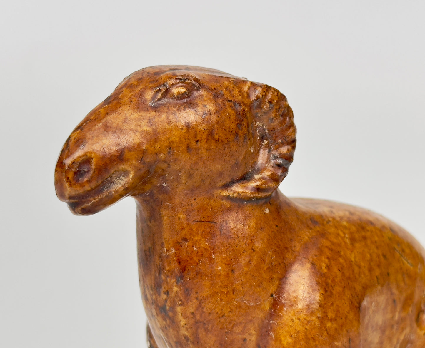 AMBER-GLAZED POTTERY FIGURE OF SHEEP, TANG-LIAO DYNASTY (7-12TH CENTURY)