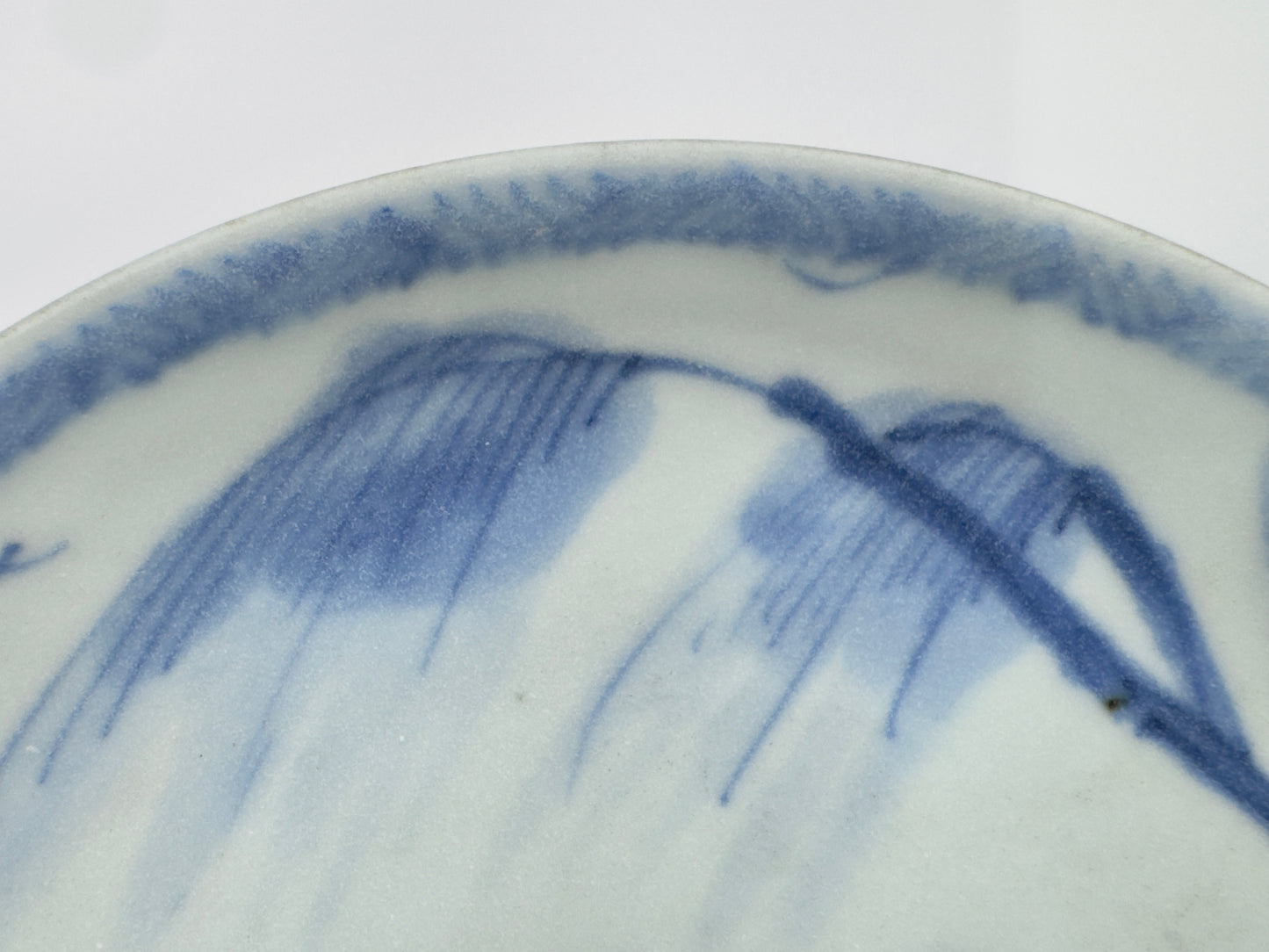 SCHOLARLY REPOSE BLUE AND WHITE SAUCER CIRCA 1725, QING DYNASTY, YONGZHENG REIGN