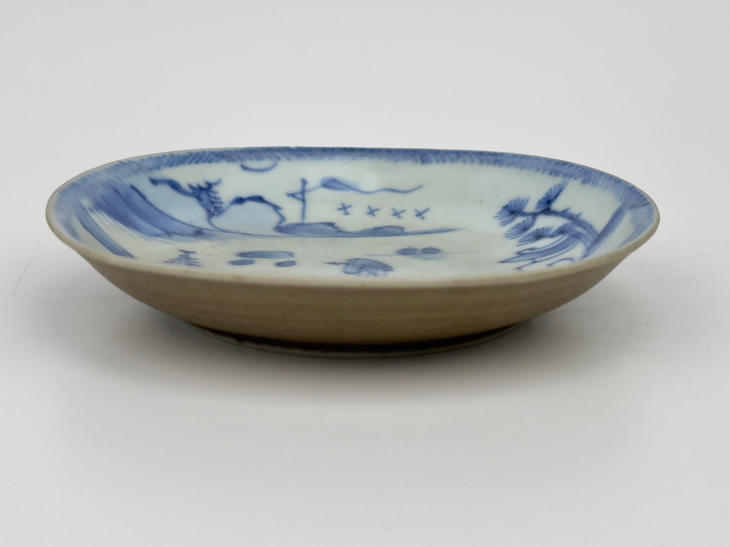 PASSING BOAT AND BRIDGE PATTERN BLUE AND WHITE TEABOWL AND SAUCER SET CIRCA 1725, QING DYNASTY, YONGZHENG ERA