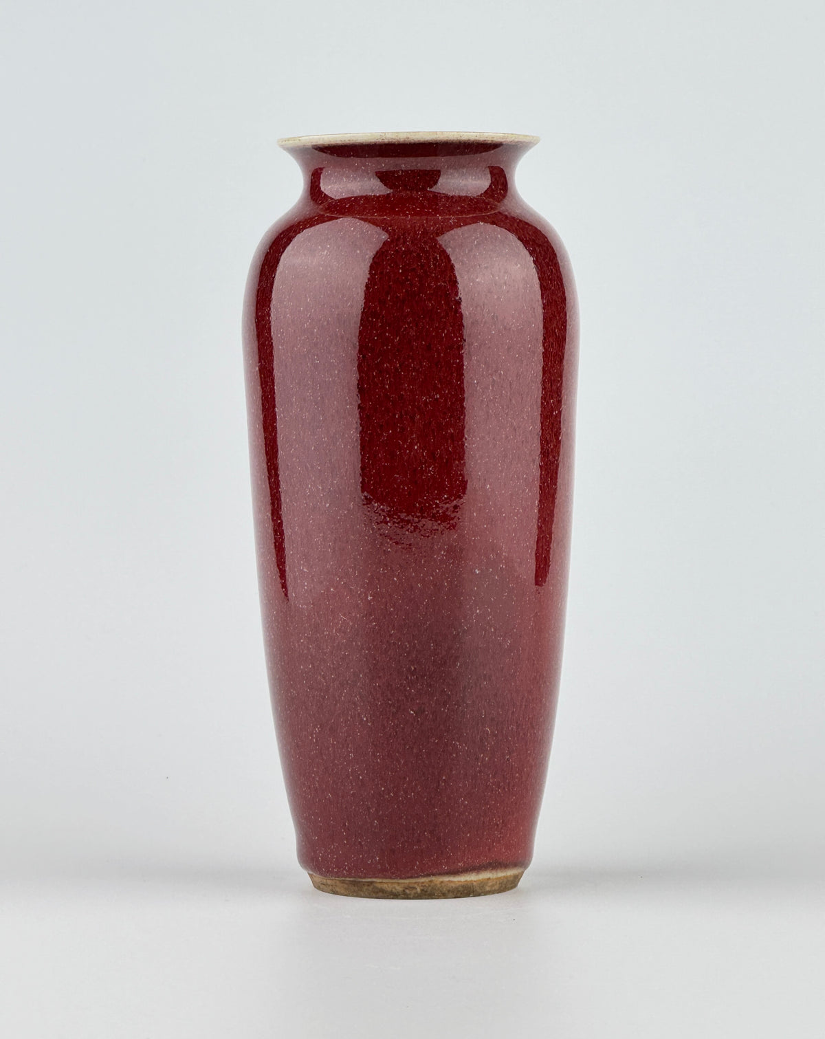 Qing Dynasty Langyao copper-red glazed porcelain vase with glossy purplish-red glaze and elegant balanced form.