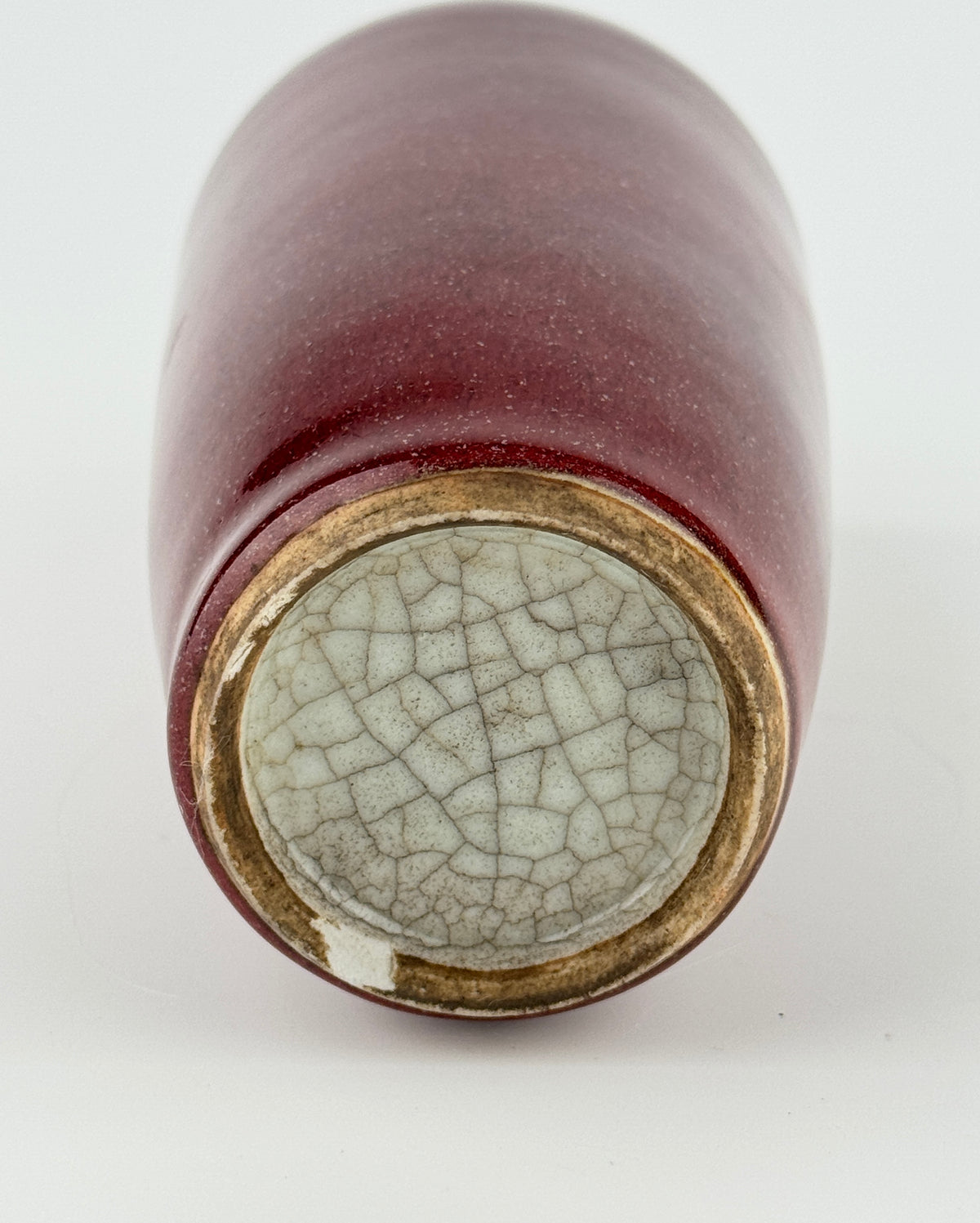 Qing Dynasty Langyao copper-red glazed porcelain vase with glossy purplish-red glaze and elegant balanced form.