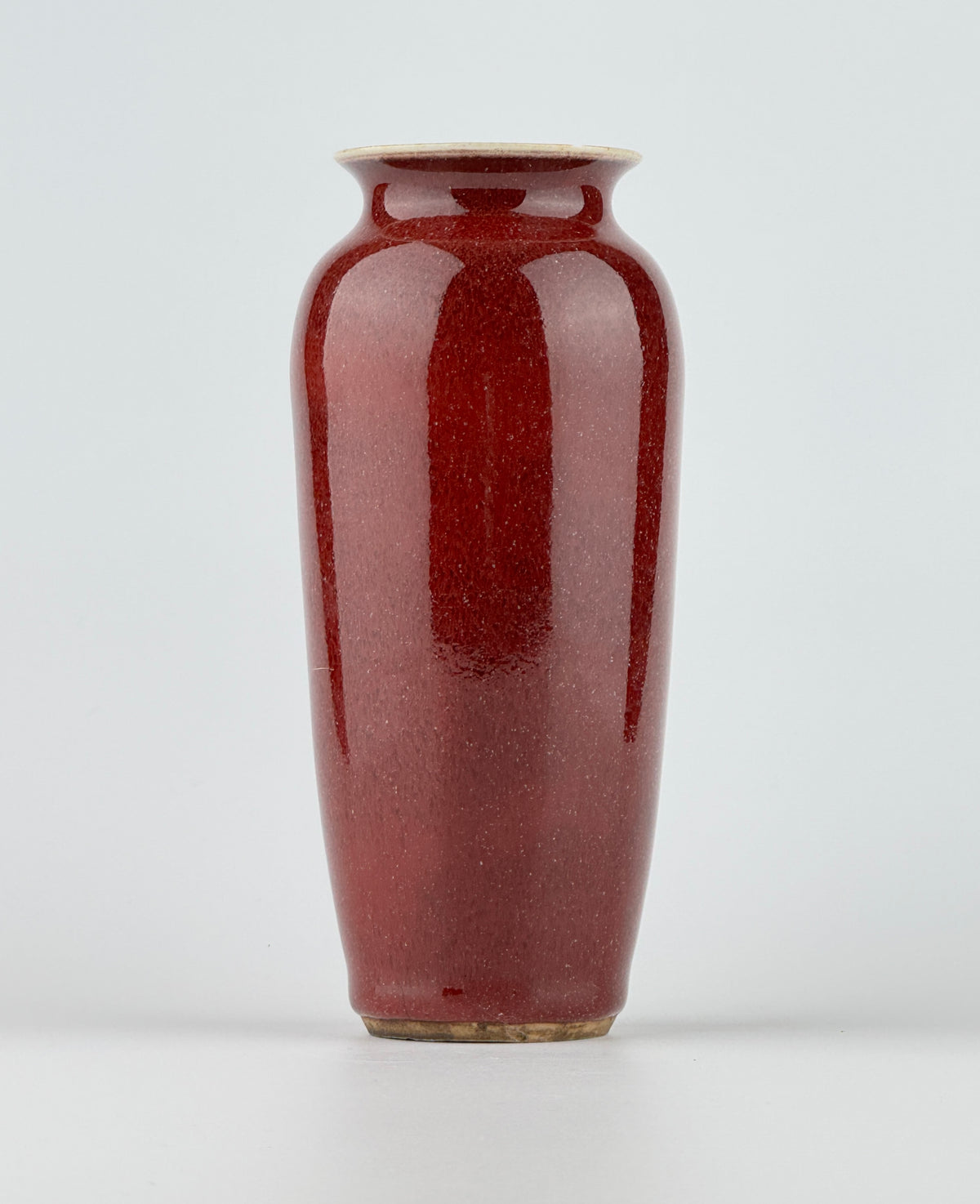 Qing Dynasty Langyao copper-red glazed porcelain vase with glossy purplish-red glaze and elegant balanced form.